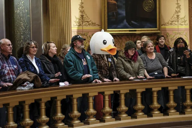 Protesters gather in the Capitol rotunda in Lansing, Michigan on December 5, 2018 to oppose the strategy of the Republican-led senate, a so-called lame-duck strategy. (Photo by Robert Killips/AP Photo)