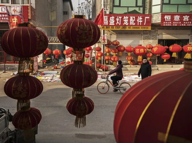 Traditional red lanterns used during festive occasions hang in the street on January 24, 2019 in the village of Tuntou, in Hebei province, China. The village of Tuntou, in Hebei province, proclaims itself the lantern capital of China, producing millions of the symbolic red decorations associated with the countrys biggest holiday of the year. In Chinese culture, the color red is meant to bring luck and happiness, and the fabric of each lantern is adorned with characters wishing for health, peace, and prosperity. It is a five-hundred year old tradition that dates back to the Qing Dynasty, and is an enduring contrast to Chinas modern cities and rapid growth. In Tuntou, most of the production is at small, family-owned factories that supply markets across China, Asia, and abroad. The Lunar New Year falls on February 5, 2019, and marks the beginning of Year of the Pig. In China, the holiday period is known as Spring Festival, and sees a massive annual migration as hundreds of millions of people travel to reach their ancestral homes to visit family. (Photo by Kevin Frayer/Getty Images)