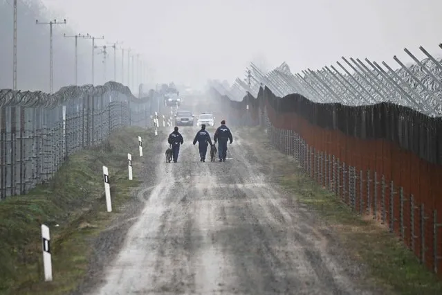 Hungarian border police officiers patrol on December 15, 2022 at the Hungarian-Serbian border, close to Kelebia village. In August 2022, the Hungarian government decided to strengthen the already existing 165-kilometer security border fence and build a new border protection system at the south part of the border. (Photo by Attila Kisbenedek/AFP Photo)