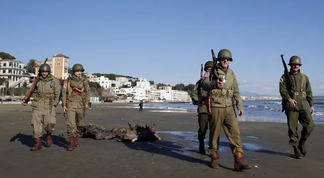 Volunteers wearing the uniform of the U.S. army patrol as they participate in the re-enactment of a World War Two landing to mark its 70th anniversary in Anzio, near Rome, January 25, 2014. (Photo by Stefano Rellandini/Reuters)