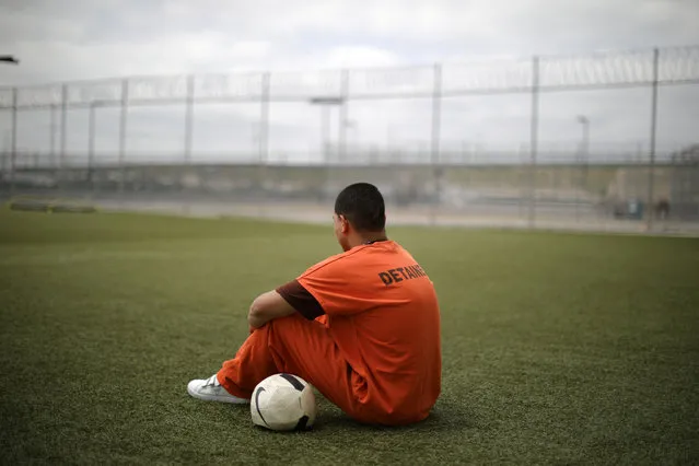 A detainee sits with a soccer ball at Otay Mesa immigration detention center in San Diego, California, U.S. May 18, 2018. (Photo by Lucy Nicholson/Reuters)