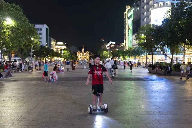 A boy rides an electric hoverboard in Ho Chi Minh City, Vietnam, January 11, 2024. (Photo by Jae C. Hong/AP Photo)