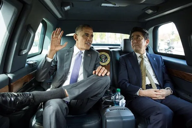 U.S. President Barack Obama speaks with Japanese Prime Minister Shinzo Abe (R) as they ride together en route to the Lincoln Memorial in Washington in this April 27, 2015 handout photo. (Photo by Pete Souza/Reuters/White House)