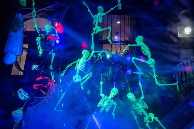 A home is decorated with glow in the dark skeletons in Murray Hill for Halloween on October 25, 2021 in New York City. Many Halloween events and large-scale decorations are back this year after many events were cancelled in 2020 due to the coronavirus pandemic. (Photo by Alexi Rosenfeld/Getty Images)
