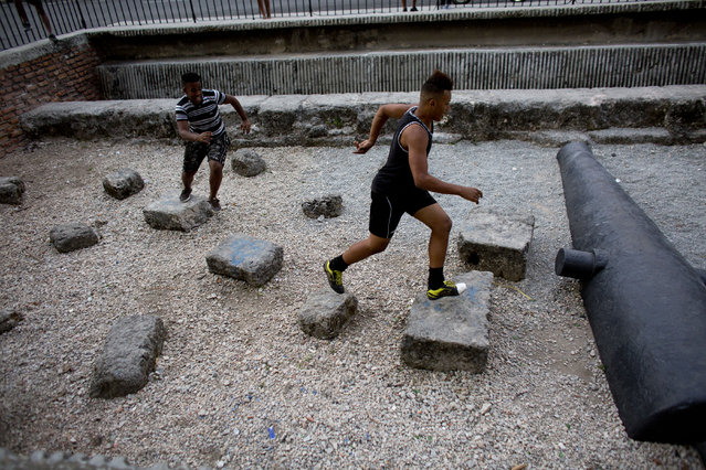 Boys play a version of tag atop remnants of colonial era fortifications in Havana, Cuba, Friday, March 18, 2016. (Photo by Rebecca Blackwell/AP Photo)