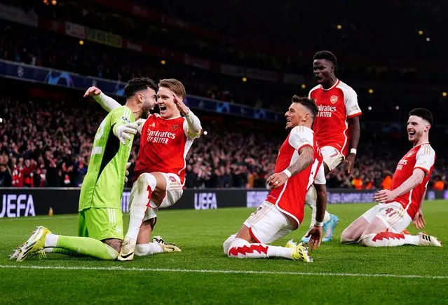 Arsenal's David Raya, Martin Odegaard, Ben White, Bukayo Saka and Declan Rice celebrate after winning the penalty shoot-out of the UEFA Champions League Round of 16, second leg match at the Emirates Stadium, London on Tuesday, March 12, 2024. (Photo by Zac Goodwin/PA Images via Getty Images)