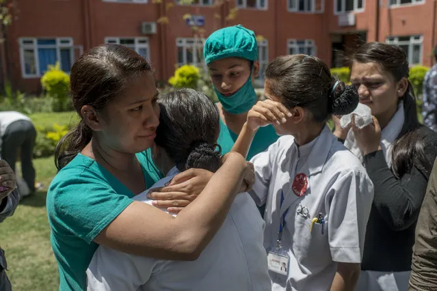 Medics console each other at a Police Hospital in Kathmandu following a further major earthquake on May 12, 2015 in Kathmandu, Nepal. (Photo by Jonas Gratzer/Getty Images)