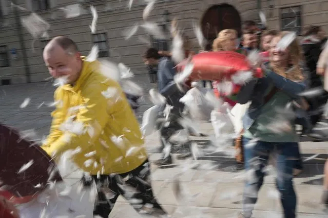 People fight with pillows during the International Pillow Fight Day in Vienna, Austria on April 2, 2016. (Photo by Joe Klamar/AFP Photo)