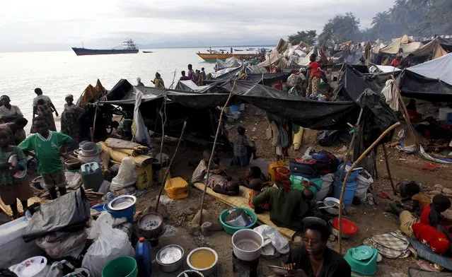 A general view shows Burundian refugees as they prepare food within their makeshift shelters while they gather on the shores of Lake Tanganyika in Kagunga village in Kigoma region in western Tanzania, to wait for MV Liemba to transport them to Kigoma township, May 17, 2015. (Photo by Thomas Mukoya/Reuters)