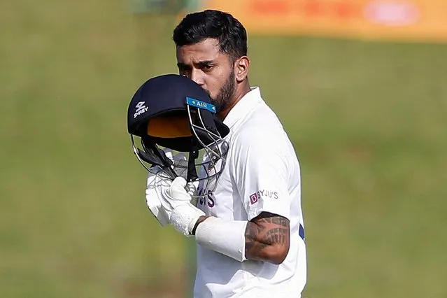 India's KL Rahul kisses his helmet as he celebrates after scoring a century (100 runs) during the first day of the first Test cricket match between South Africa and India at SuperSport Park in Centurion on December 26, 2021. (Photo by Phill Magakoe/AFP Photo)