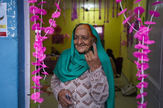 An elderly woman shows the indelible ink mark on her finger after casting vote at women only booth during the first round of polling of India’s national election in Doda district, Jammu and Kashmir, India, Friday, April 19, 2024. (Photo by Channi Anand/AP Photo)