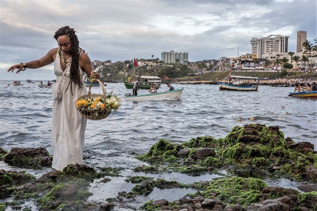 Worshippers take part in the traditional ceremony of Iemanja, the Goddess of the Sea of the syncretic Afro-Brazilian religion Umbanda at the Rio Vermelho neighborhood, in Salvador, Bahia, Brazil on February 2, 2023. (Photo by Antonello Veneri/AFP Photo)