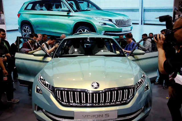 Visitors gather around a Skoda Vision S presented at the Auto China 2016 show in Beijing, China April 25, 2016. (Photo by Damir Sagolj/Reuters)