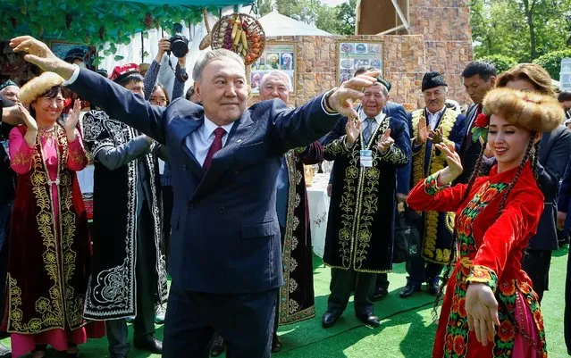 Kazakhstan’s President Nursultan Nazarbayev dances with artists during celebrations to mark Kazakhstan People's Unity Day in Almaty, Kazakhstan, May 1, 2016. (Photo by Shamil Zhumatov/Reuters)