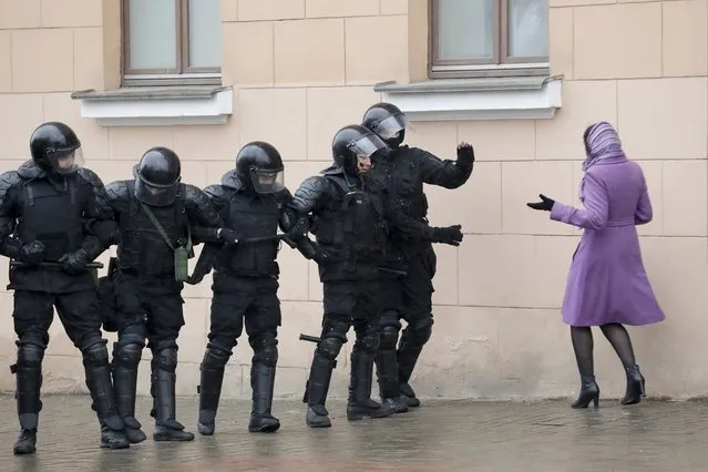 A woman argues as Belarus police block a street during an opposition rally in Minsk, Belarus, Saturday, March 25, 2017. (Photo by Sergei Grits/AP Photo)