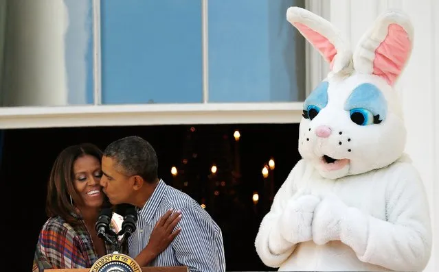 President Barack Obama kisses first lady Michelle Obama at the annual White House Easter Egg Roll on the South Lawn April 21, 2014 in Washington, DC. (Photo by Win McNamee/Getty Images)