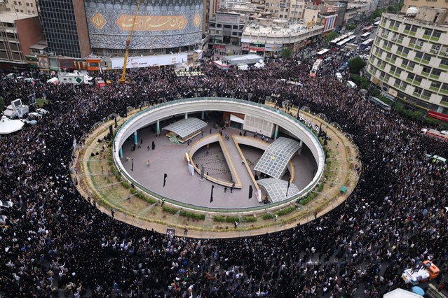 Iranians gather at Valiasr Square in central Tehran to mourn the death of President Ebrahim Raisi and Foreign Minister Hossein Amir-Abdollahian in a helicopter crash the previous day, on May 20, 2024. Iranian president Ebrahim Raisi was confirmed dead on May 20 after search and rescue teams found his crashed helicopter in a fog-shrouded mountain region, sparking mourning in the Islamic republic. (Photo by Atta Kenare/AFP Photo)