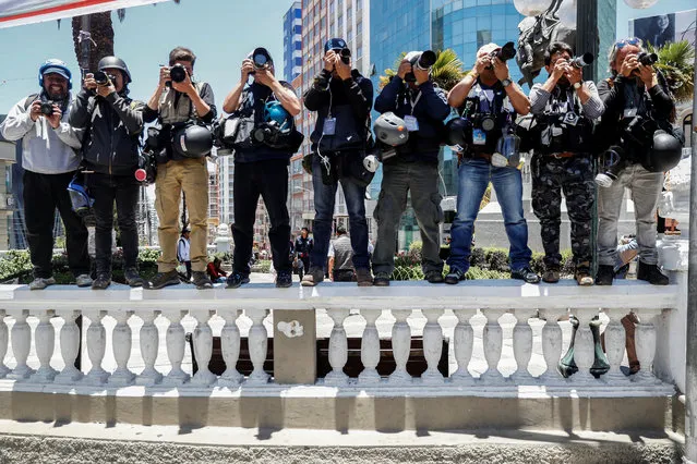 News photographers cover the march of miners supporting Bolivia's President Evo Morales in La Paz, Bolivia, October 30, 2019. (Photo by Kai Pfaffenbach/Reuters)