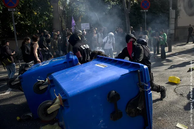 Students set up a barricade during a demonstration on February 29, 2012 in Barcelona