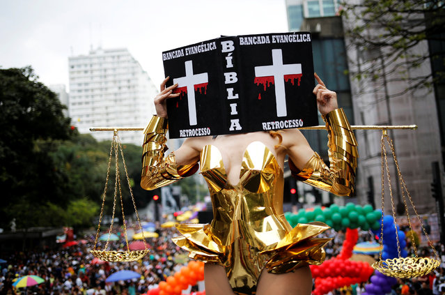 Transgender Viviany Beleboni holds a replica Bible that reads “Evangelical leadership, regression” in the annual Gay Pride parade along Paulista Avenue in Sao Paulo, Brazil, May 29, 2016. (Photo by Nacho Doce/Reuters)