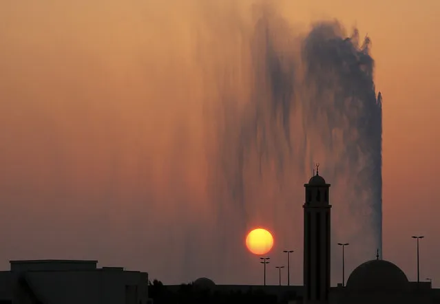 The sun sets behind a mosque and the landmark Jiddah fountain, in Jiddah, Saudi Arabia, Thursday, August 29, 2019. (Photo by Amr Nabil/AP Photo)