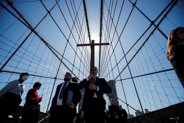 People participate in the “Way of the Cross Over the Brooklyn Bridge Ceremony” hosted yearly on the Christian holy day of Good Friday marking the crucifixion of Jesus Christ, in New York City, U.S., April 15, 2022. (Photo by Eduardo Munoz/Reuters)