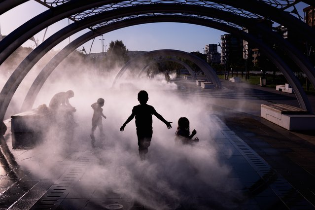 Children enjoy water sprays at Kartal Beach Park during hot days of summer season in Istanbul, Turkiye on July 18, 2024. (Photo by Murat Bakmaz/Anadolu via Getty Images)