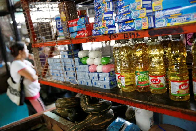 Bottles of cooking oil that are made in Colombia are displayed at a stall that sells food and staple items at a market in La Fria, Venezuela, June 2, 2016. (Photo by Carlos Garcia Rawlins/Reuters)