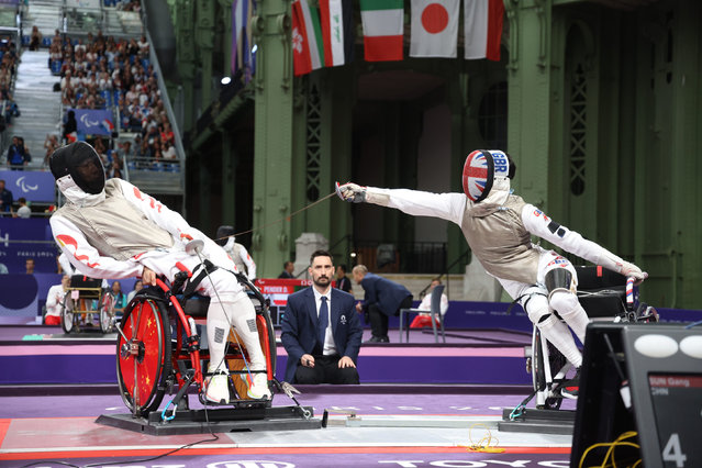 The wheelchair fencers Sun Gang of China and Oliver Lam-Watson of Team GB during the Men's Foil Category A Table of 16 on day seven of the Paris 2024 Summer Paralympic Games at Grand Palais on September 04, 2024 in Paris, France. (Photo by ParalympicsGB/PA Wire)