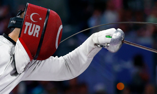 Hakan Akkaya of Turkey in action with Emanuele Lambertini of Italy during their wheelchair fencing men’s epee category bronze medal bout on September 6, 2024. (Photo by Gonzalo Fuentes/Reuters)