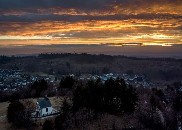 A chapel is pictured in the village of Oberreifenberg near Frankfurt, Germany, as the sun sets on Sunday, March 13, 2022. (Photo by Michael Probst/AP Photo)