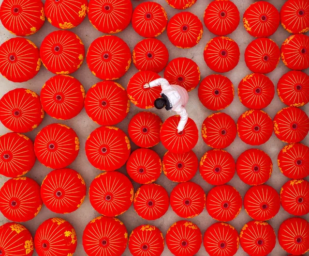 A worker at a factory making red lanterns in Sihong County, Jiangsu Province, China on December 23, 2019. (Photo by Costfoto/Barcroft Media)