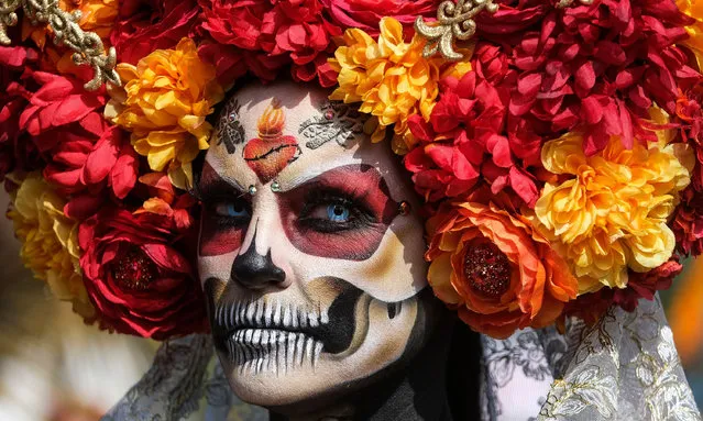 A participant displays her makeup and head dress at the Dia de los Muertos (Day of the Dead) festival at Hollywood Forever Cemetery in Los Angeles, California on October 30, 2021. (Photo by Ringo Chiu/ZUMA Press Wire/Rex Features/Shutterstock)