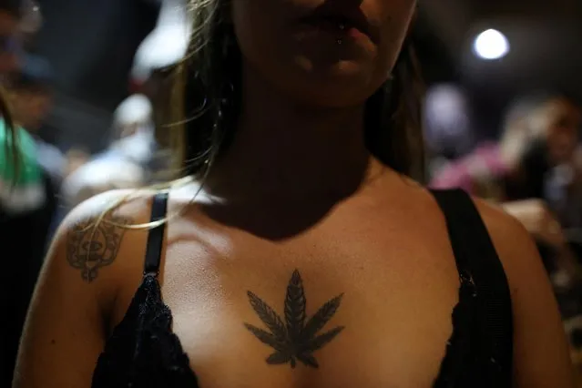 A woman with the cannabis leaf tattooed on her chest takes part in the march for marijuana, in favor of the decriminalization of cannabis, in Sao Paulo, Brazil on June 11, 2022. (Photo by Amanda Perobelli/Reuters)
