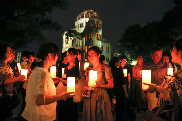 People holding candles gather for the Peace Candle vigil in front of the Atomic Bomb Dome (Rear) to comfort soul of victims of the 06 August 1945 atomic bombing at Hiroshima Peace Memorial Park in Hiroshima, western Japan, 05 August 2017. Hiroshima will mark 72nd anniversary of the atomic bombing on 06 August 2017. (Photo by Kimimasa Mayama/EPA)