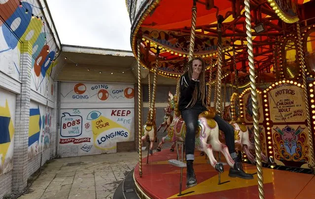 People ride a carousel at “Dismaland”, a theme park-styled art installation by British artist Banksy, at Weston-Super-Mare in southwest England, Britain, August 20, 2015. (Photo by Toby Melville/Reuters)