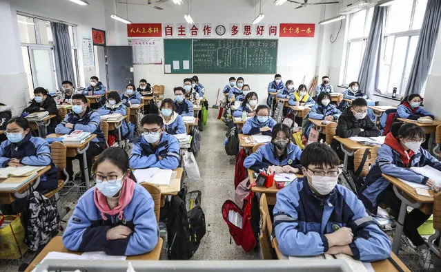 Students sit in a classroom as grade three students in middle school and high school return after the term opening was delayed due to the COVID-19 coronavirus outbreak, in Huaian in China's eastern Jiangsu province on March 30, 2020. (Photo by AFP Photo/China Stringer Network)