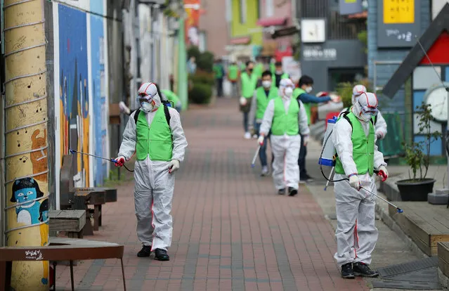 Health workers disinfect a street to curb the spread of coronavirus in Daegu, South Korea, 11 April 2020. (Photo by Yonhap/EPA/EFE/Rex Features/Shutterstock)