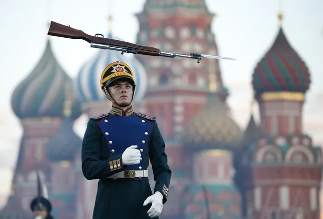 A member of the Band of the Moscow Suvorov Military Music College from Russia performs during the dress rehearsal of the International Military Music Festival “Spasskaya Tower” in front of the St. Basil's Cathedral in Red Square in Moscow, August 29, 2014. Military bands from different countries will participate in the tattoo starting from August 30 to September 7. (Photo by Maxim Zmeyev/Reuters)