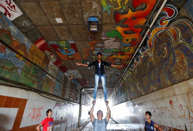 Members of an acrobatic group practice at a pedestrian underpass in Mumbai, India, July 28, 2016. (Photo by Danish Siddiqui/Reuters)