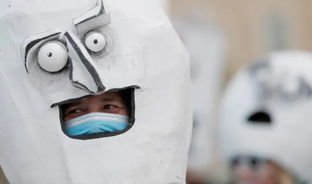 Protesters wear masks during a protest outside Greek parliament by actors and workers in the music industry in demand of state aid to mitigate financial losses due to the coronavirus disease (COVID-19) outbreak in Athens, Greece, May 7, 2020. (Photo by Goran Tomasevic/Reuters)