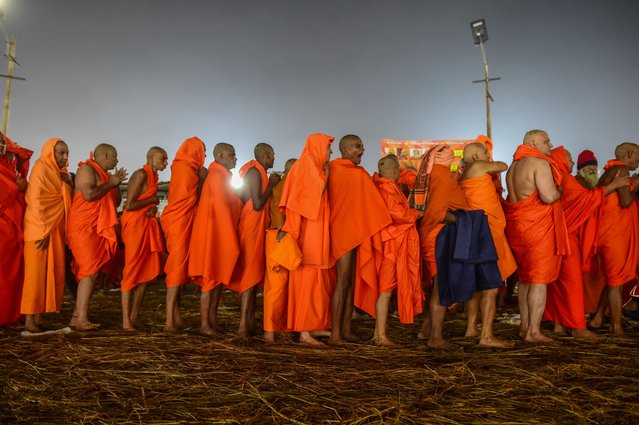 Newly-initiated Naga Sadhus (Hindu holy men) take part in a religious rituals inside a camp during the Maha Kumbh Mela festival on January 20, 2025 in Allahabad, India. Kumbh Mela in 2025 is a Maha Kumbh, which is a significant Hindu festival celebrated once every 144 years at Prayagraj (Allahabad). Scheduled from January 13 to February 26, 2025, it attracts millions of devotees for ritual bathing at the confluence of the Ganges, Yamuna, and the mythical Saraswati rivers, marking a unique spiritual occasion with enhanced significance compared to regular Kumbh Mela. (Photo by Ritesh Shukla/Getty Images)