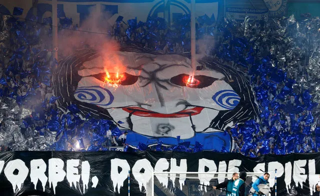 Magdeburg fans display a banner and let flares off before their match against Borussia Dortmund in Magdeburg, Germany on October 24, 2017. (Photo by Hannibal Hanschke/Reuters)