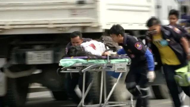 Rescuers and medical officers push an injured person on a gurney at the site of a bomb blast in Hua Hin, south of Bangkok, Thailand, in this still image taken from video August 12, 2016. (Photo by Reuters/Reuters TV)