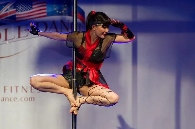 A competitor participates at the World Pole Dancing Championship 2012 held at the Volkshaus on November 10, 2012 in Zurich, Switzerland. The public's perception of pole dancing has recently changed to become a popular sport combining physical strength, technique and choreography.  (Photo by Harold Cunningham)