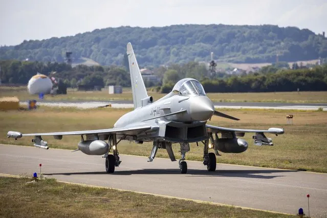A German Eurofighter gets ready for takeoff at Neuburg Air Base in Neuburg An Der Donau, Germany, Monday August 15, 2022. A group of German air force fighter jets neared Singapore on Tuesday, Aug. 16, 2022, in a marathon bid to fly them some 12,800 kilometers (8,000 miles) from their home base to Southeast Asia in just 24 hours. (Photo by Daniel Karmann/dpa via AP Photo)