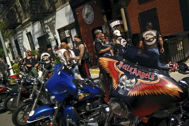 Motorcycle enthusiasts talk on East 3rd St as a large group of motorcycles gather at the Hell's Angels clubhouse in the Manhattan borough of New York, August 23, 2015. (Photo by Carlo Allegri/Reuters)