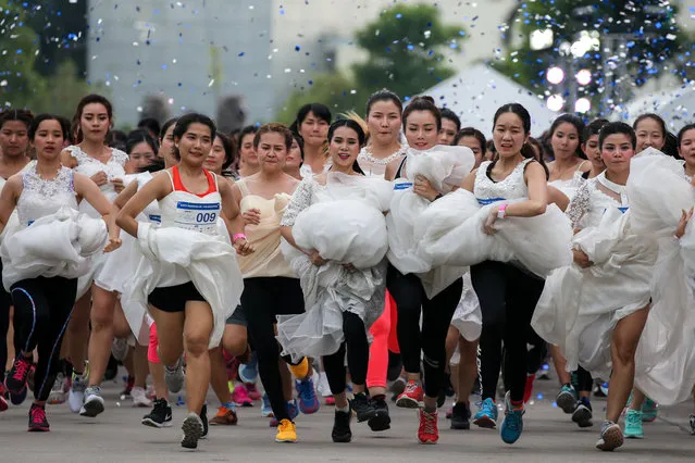 Brides-to-be participate in the “Running of the Brides” race, in Bangkok, Thailand, December 2, 2017. (Photo by Athit Perawongmetha/Reuters)