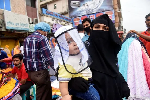 People wearing facemask gathered at a street market to buy their needs during the coronavirus outbreak in Dhaka, Bangladesh, on June 28, 2020 (Photo by Mamunur Rashid/NurPhoto via Getty Images)