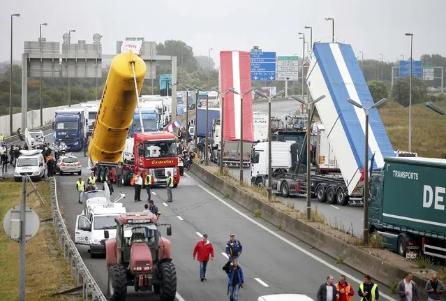 Harbor workers, truck drivers, farmers, storekeepers and residents attend a protest demonstration on the motorway against the migrant situation in Calais, France, September 5, 2016. (Photo by Charles Platiau/Reuters)
